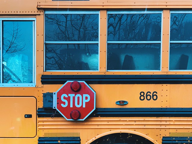 closeup of a schoolbus with Stop sign in view