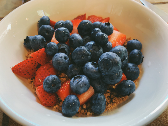 photo of blueberries and strawberries and cereal in a bowl